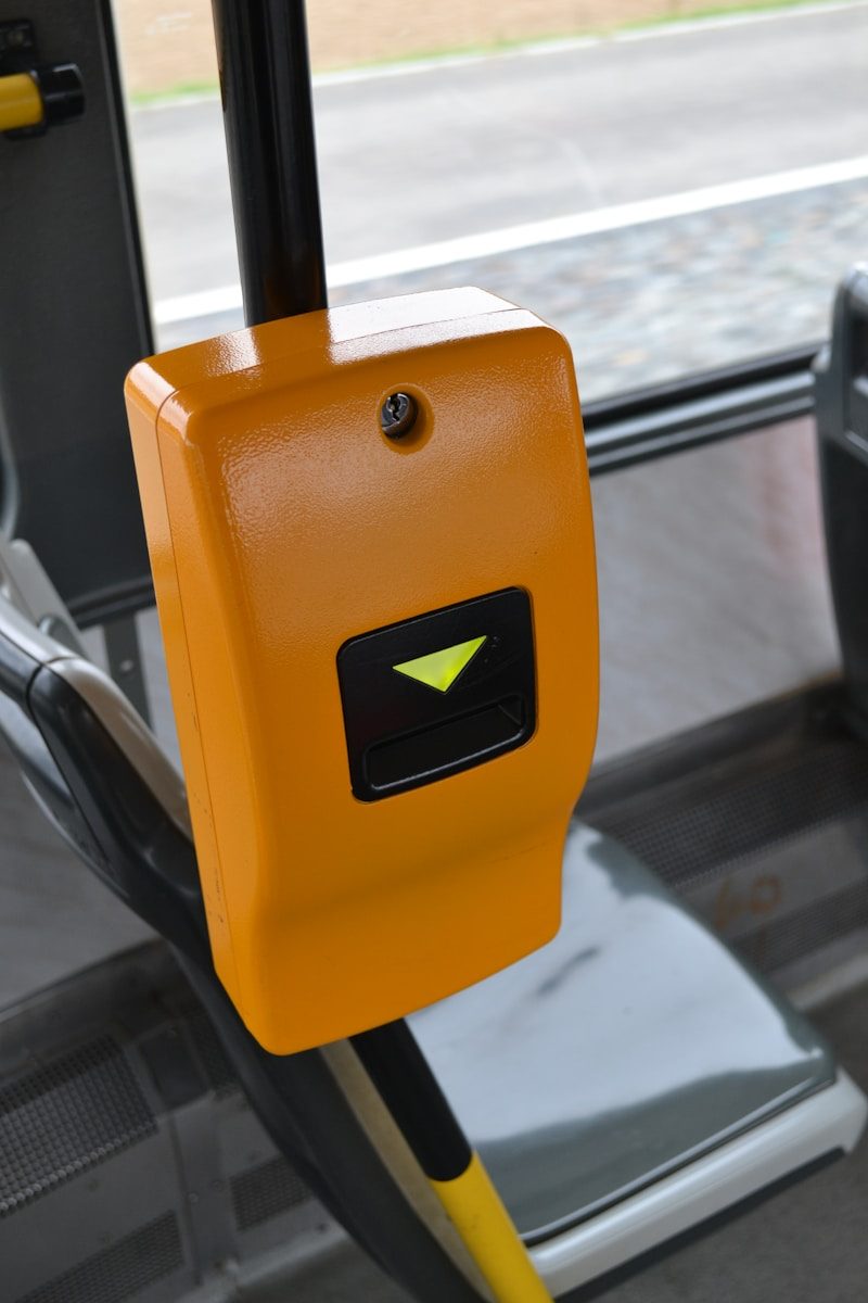 Orange ticket validator machine on a bus
